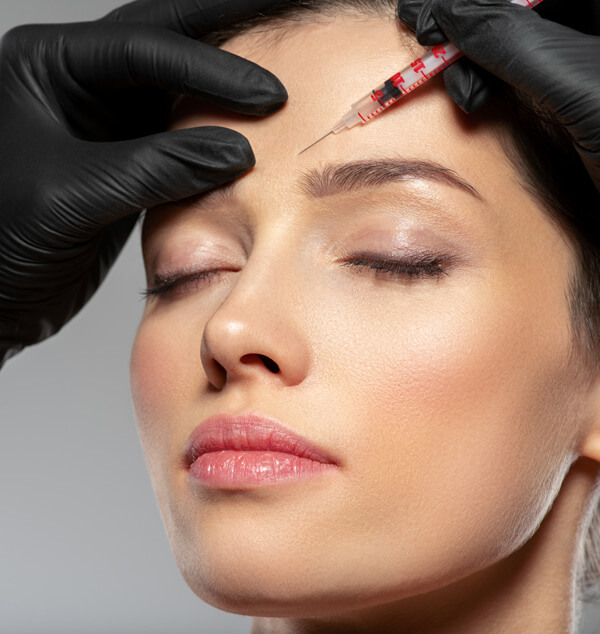 Woman getting an injection above her brow